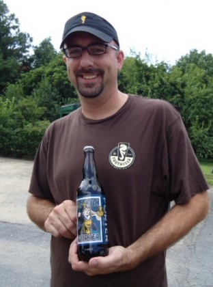 Scott Smith, sales director of Foothills Brewing, holding a bottle of their Baltic Porter