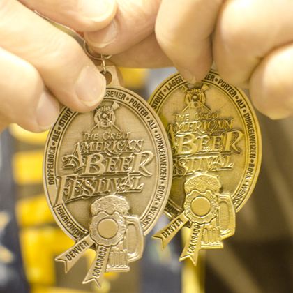 Gerald Wyman of Gella's Diner & Lb. Brewing Co. (Hays, KS) displays the silver and gold medals he won at the 2013 Great American Beer Festival. Photo by Jon Page